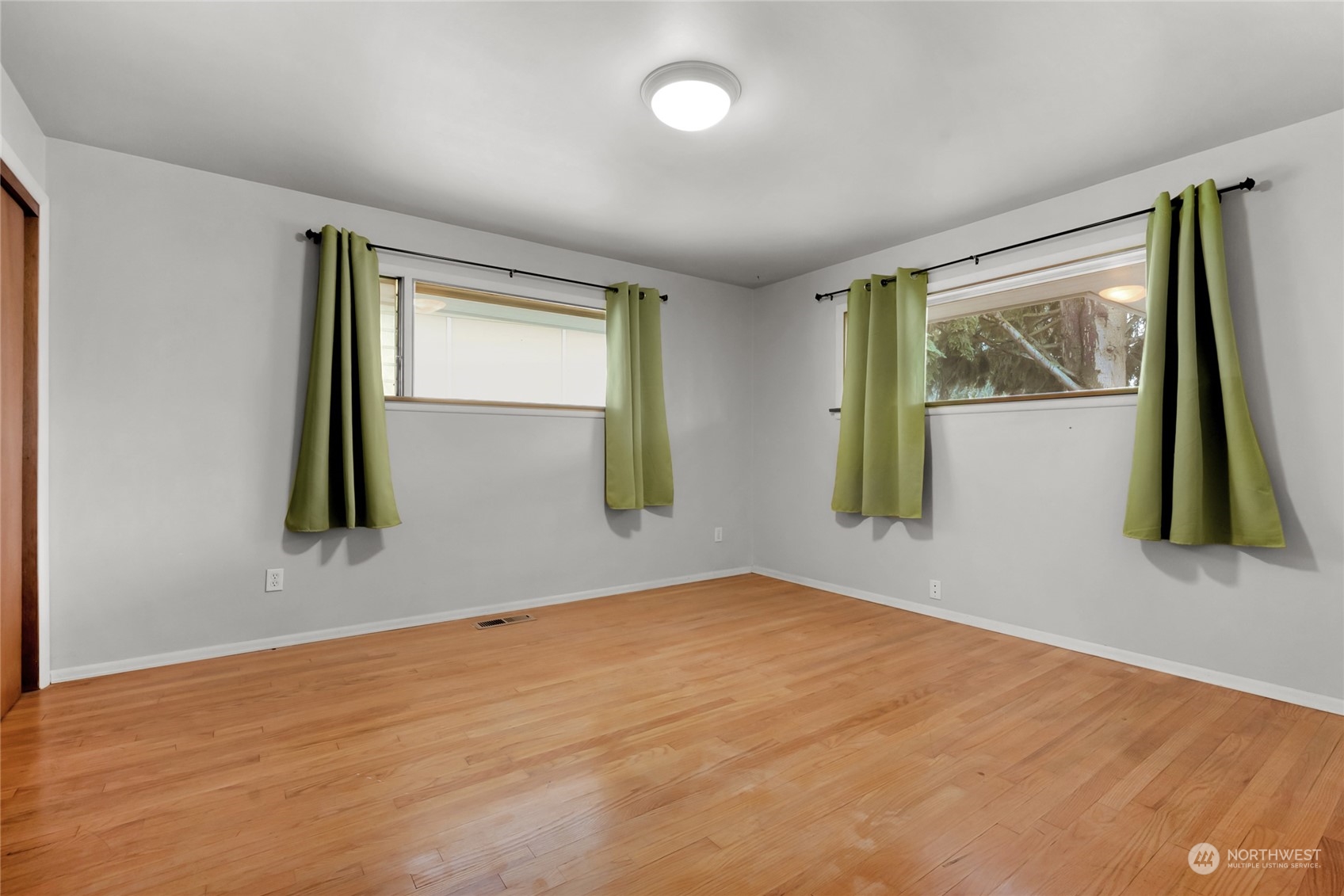 2101 Rockefeller Avenue Everett, WA 98201 - Photo 15 of 26 a view of an empty room with window and wooden floor
