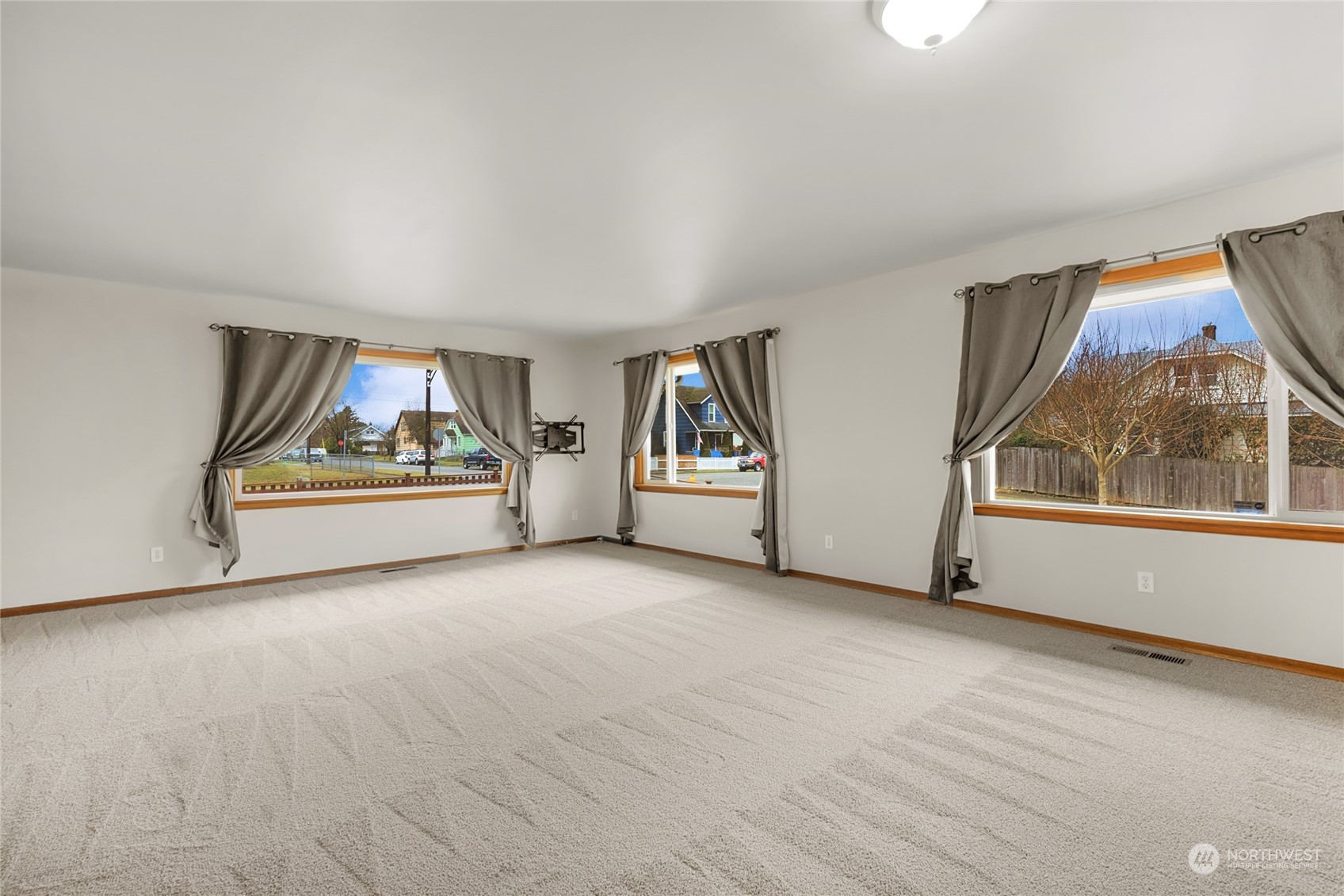 2101 Rockefeller Avenue Everett, WA 98201 - Photo 6 of 26 an empty room with wooden floor and windows