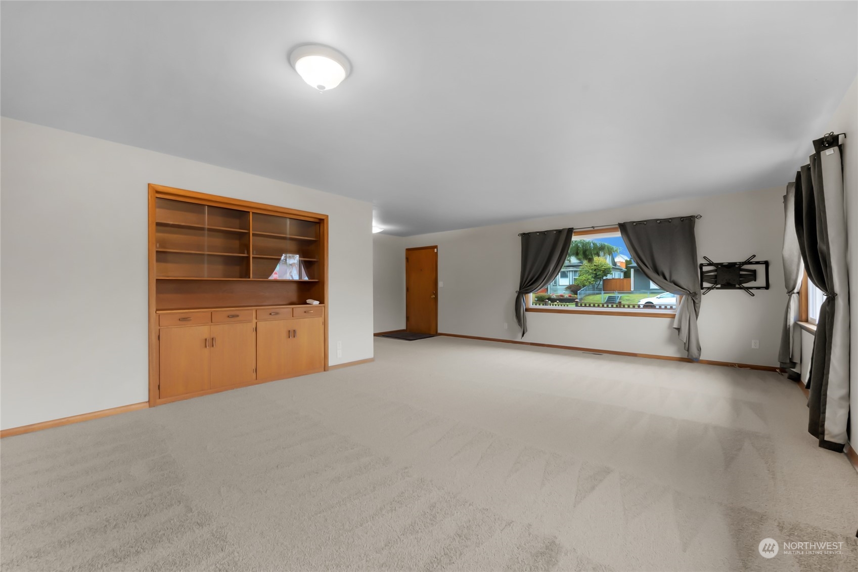 2101 Rockefeller Avenue Everett, WA 98201 - Photo 7 of 26 a view of an empty room with a window and wooden floor