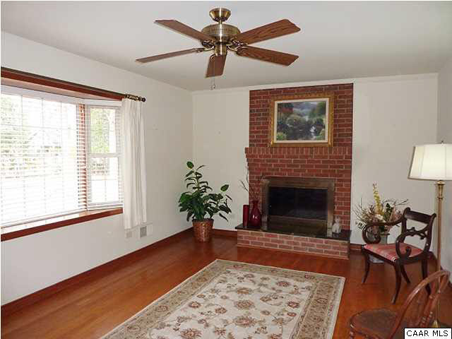 110 Elkhorn Road Charlottesville, VA 22903 - Photo 3 of 17 Formal living room with fireplace, bay window and beautiful hardwood floors.