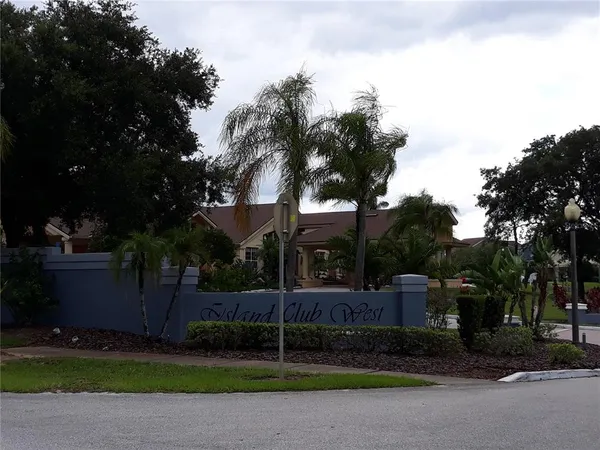a view of a house with floor to ceiling windows and a basket ball poll