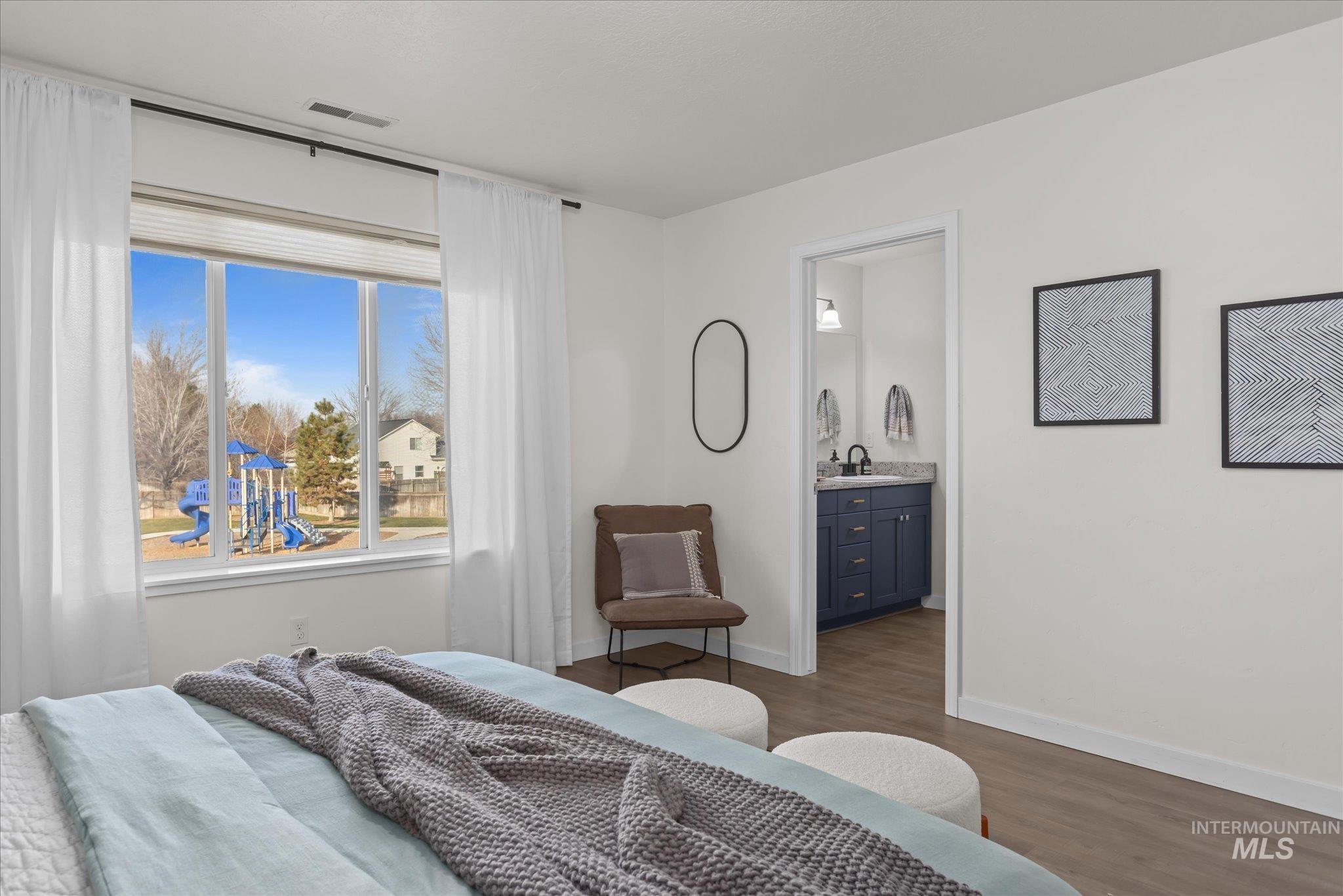 1885 North Justin Avenue Meridian, ID 83646 - Photo 18 of 27 Bedroom featuring dark wood-type flooring and ensuite bathroom