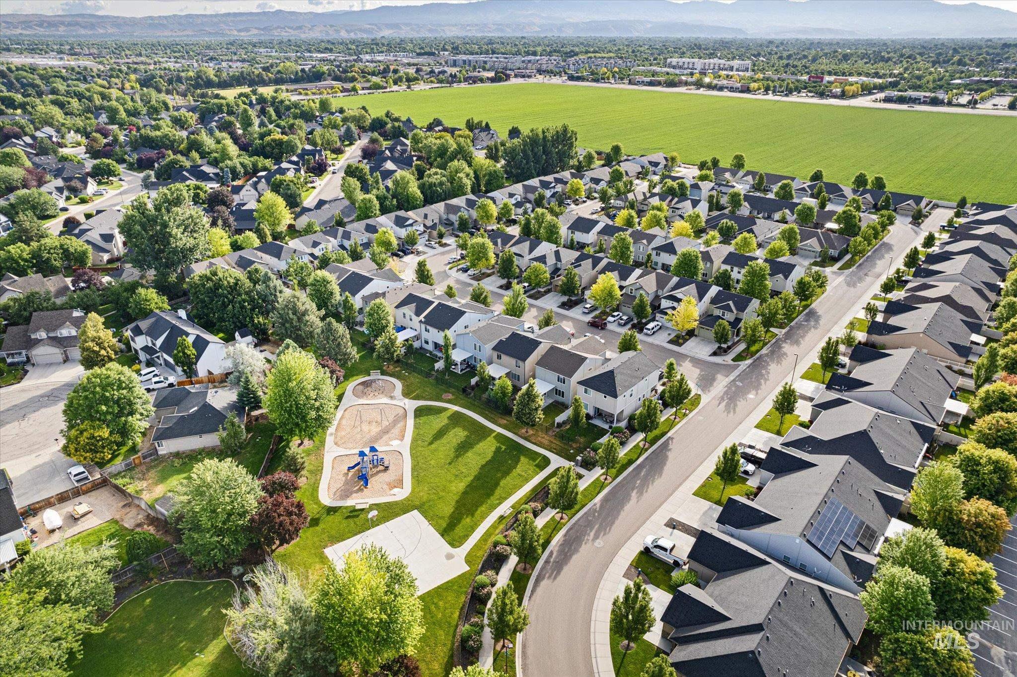 1885 North Justin Avenue Meridian, ID 83646 - Photo 26 of 27 Aerial view of property and surrounding area featuring a mountainous background and nearby suburban area