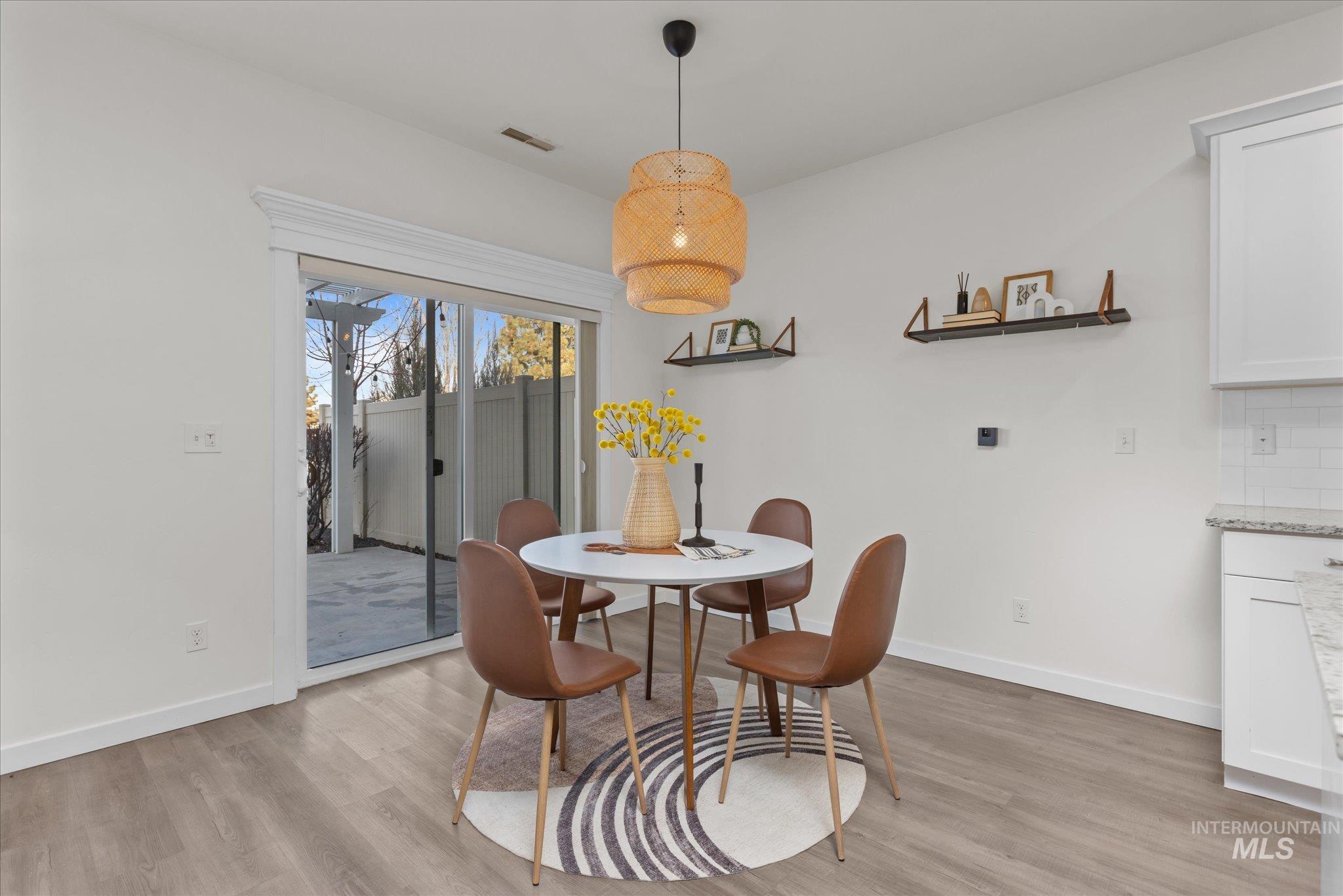 1885 North Justin Avenue Meridian, ID 83646 - Photo 9 of 27 Dining area featuring light wood-type flooring and baseboards