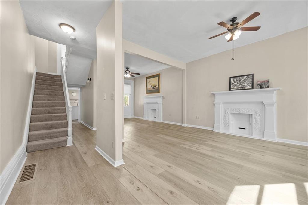 1312 Boyle Street Pittsburgh, PA 15212 - Photo 11 of 50 a view of a livingroom with wooden floor and a ceiling fan
