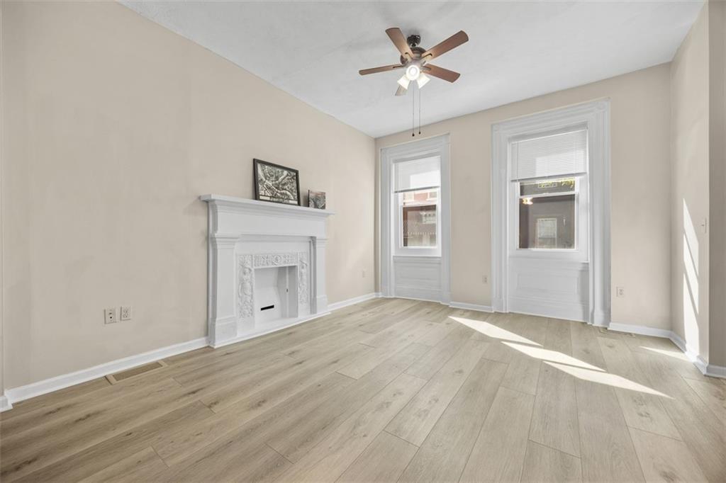 1312 Boyle Street Pittsburgh, PA 15212 - Photo 13 of 50 a view of an empty room with a fireplace and a window