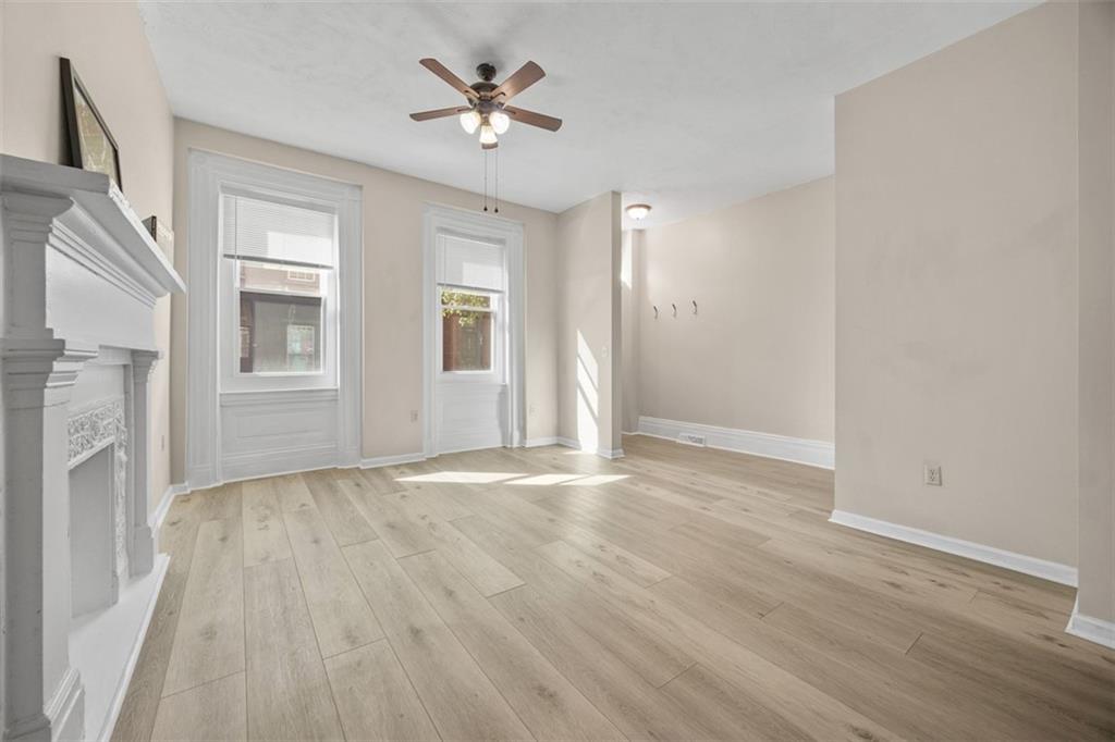 1312 Boyle Street Pittsburgh, PA 15212 - Photo 15 of 50 a view of an empty room with a window and wooden floor