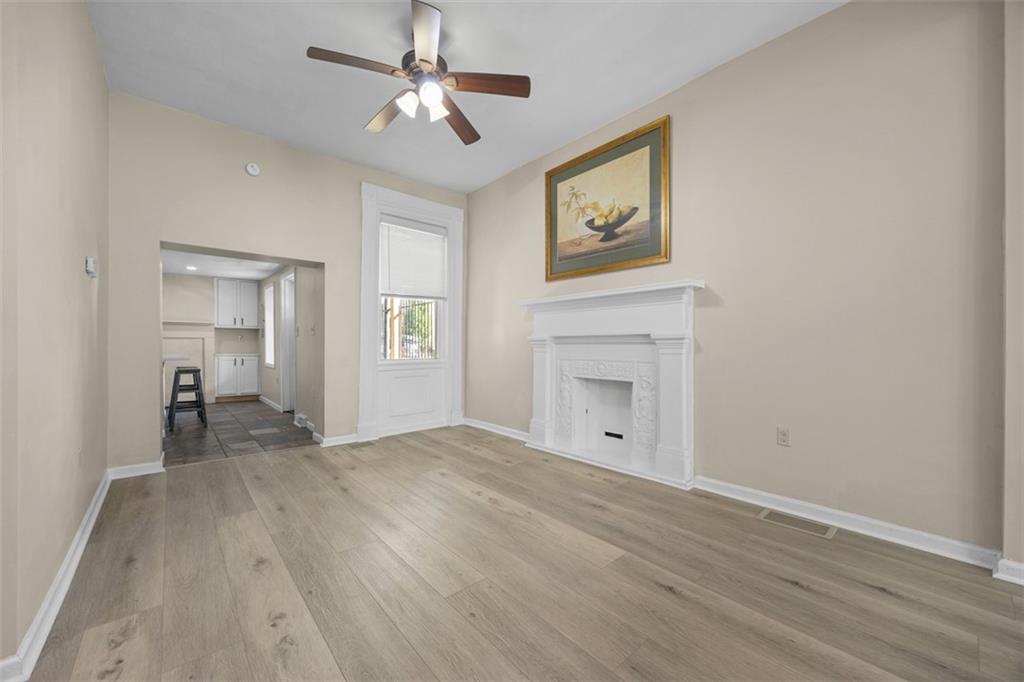 1312 Boyle Street Pittsburgh, PA 15212 - Photo 18 of 50 a view of empty room with wooden floor and ceiling fan
