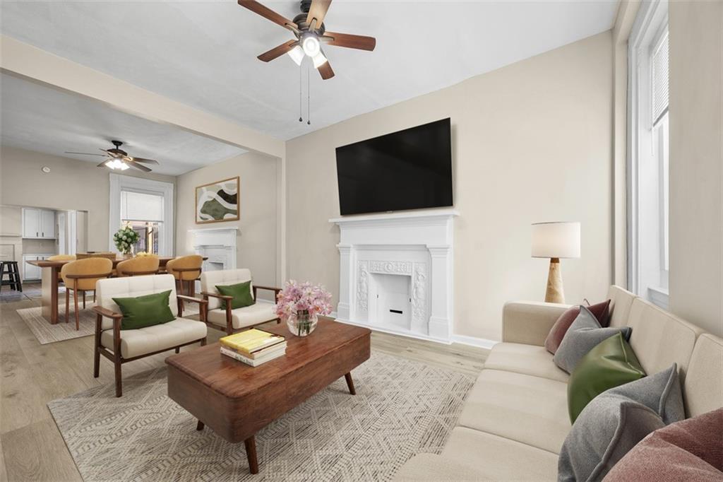 1312 Boyle Street Pittsburgh, PA 15212 - Photo 2 of 50 a living room with furniture a fireplace and a flat screen tv