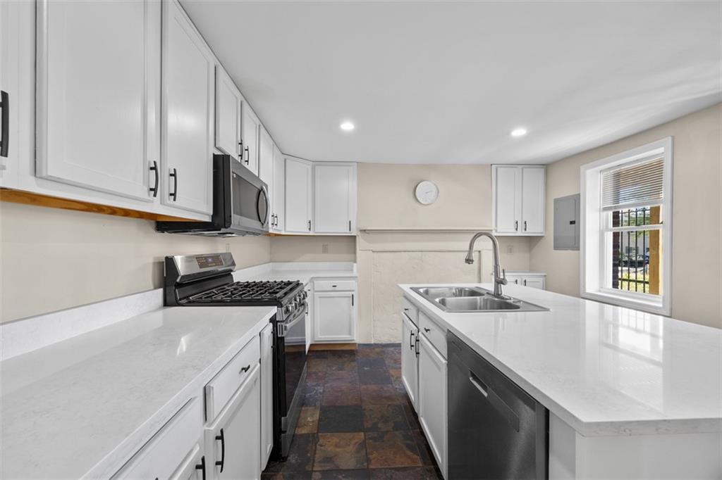 1312 Boyle Street Pittsburgh, PA 15212 - Photo 5 of 50 a kitchen with stainless steel appliances granite countertop a sink stove and cabinets
