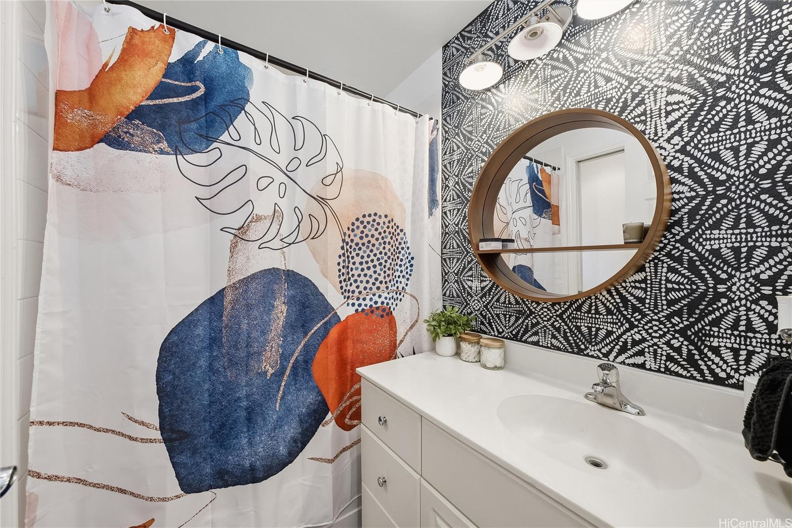 87-1958 Pakeke Street, Unit T Waianae, HI 96792 - Photo 15 of 25 a bathroom with a sink and mirror