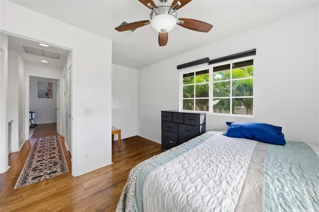 a bedroom with a bed and a large window