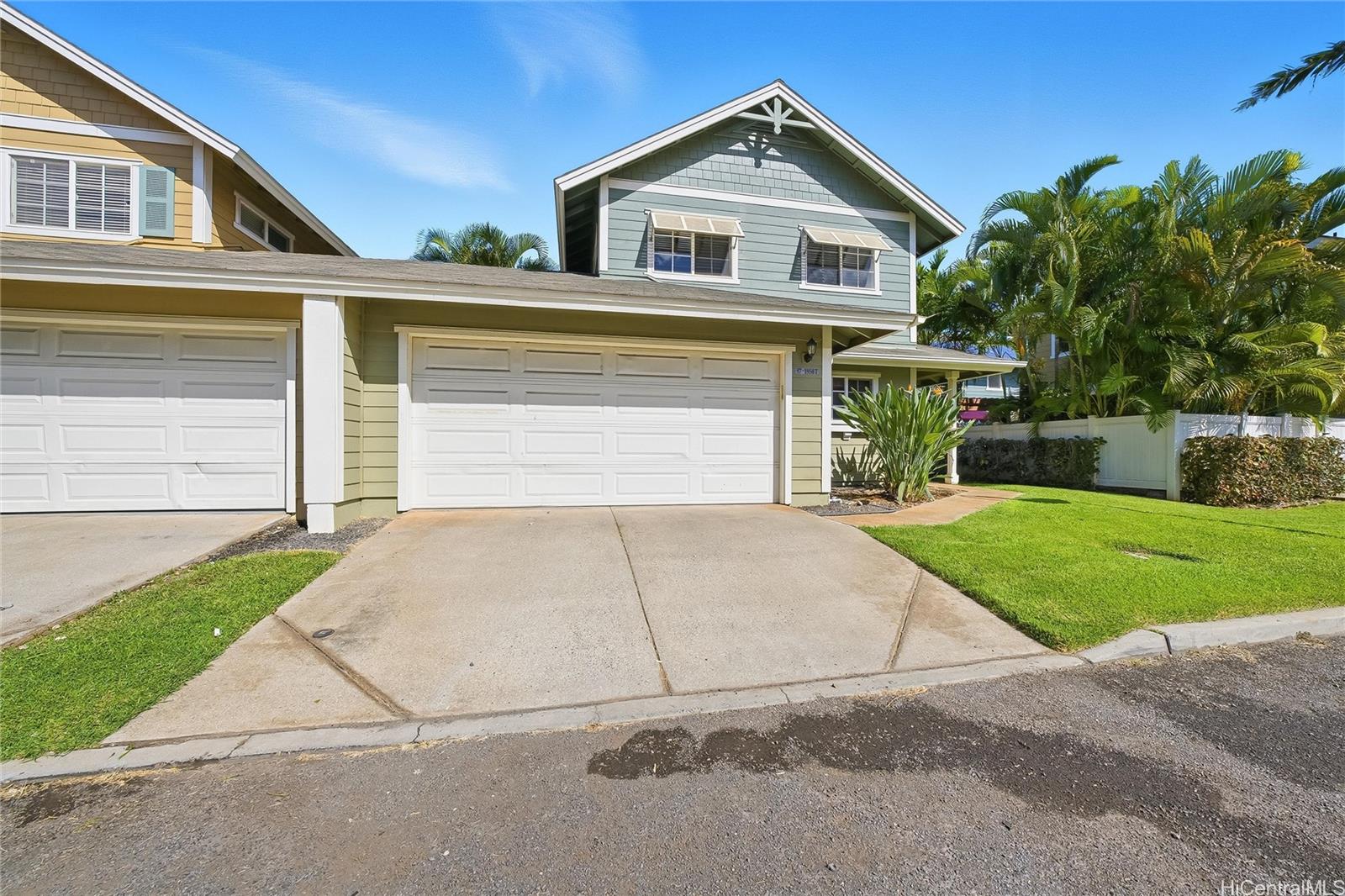 87-1958 Pakeke Street, Unit T Waianae, HI 96792 - Photo 2 of 25 a front view of a house with a yard and garage