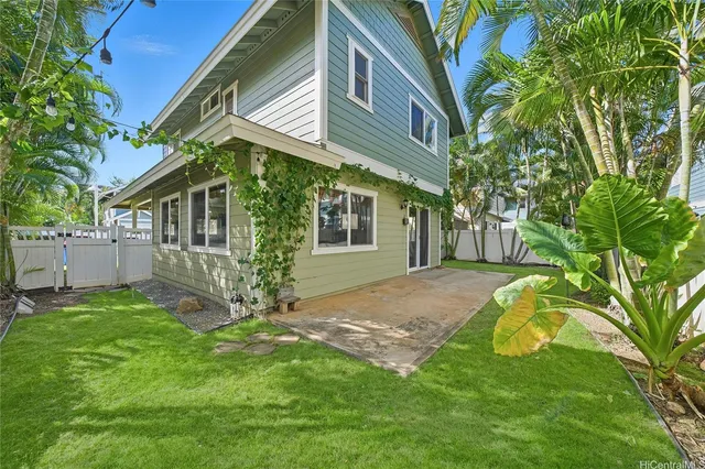 a view of a house with a yard and sitting area