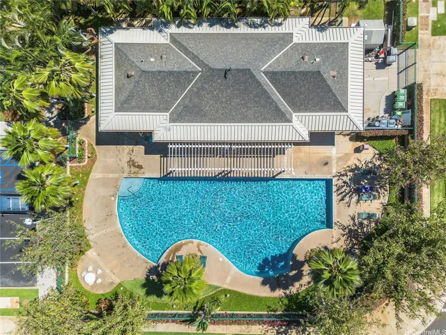 an aerial view of a house with swimming pool and outdoor seating