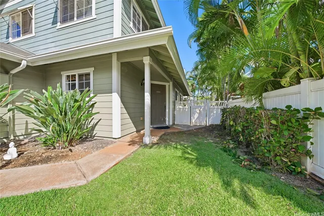a view of a house with a yard and plants
