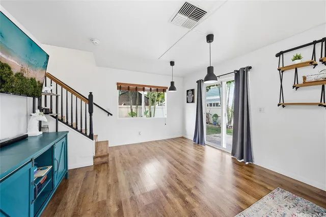 a view of an entryway with wooden floor