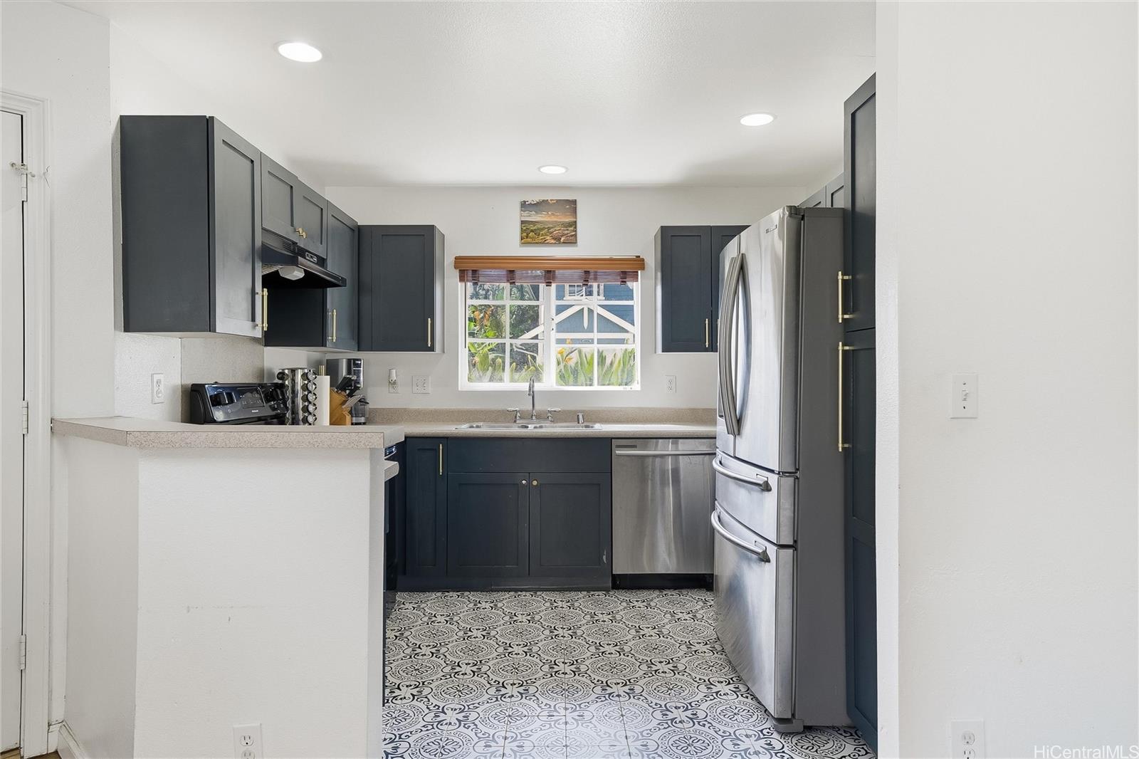 87-1958 Pakeke Street, Unit T Waianae, HI 96792 - Photo 10 of 25 a kitchen with a refrigerator and a stove top oven