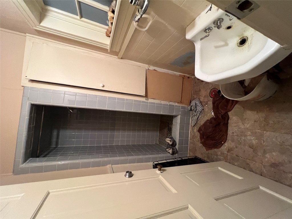 1200 Bentwood Road Austin, TX 78722 - Photo 16 of 16 a bathroom with a sink and a mirror