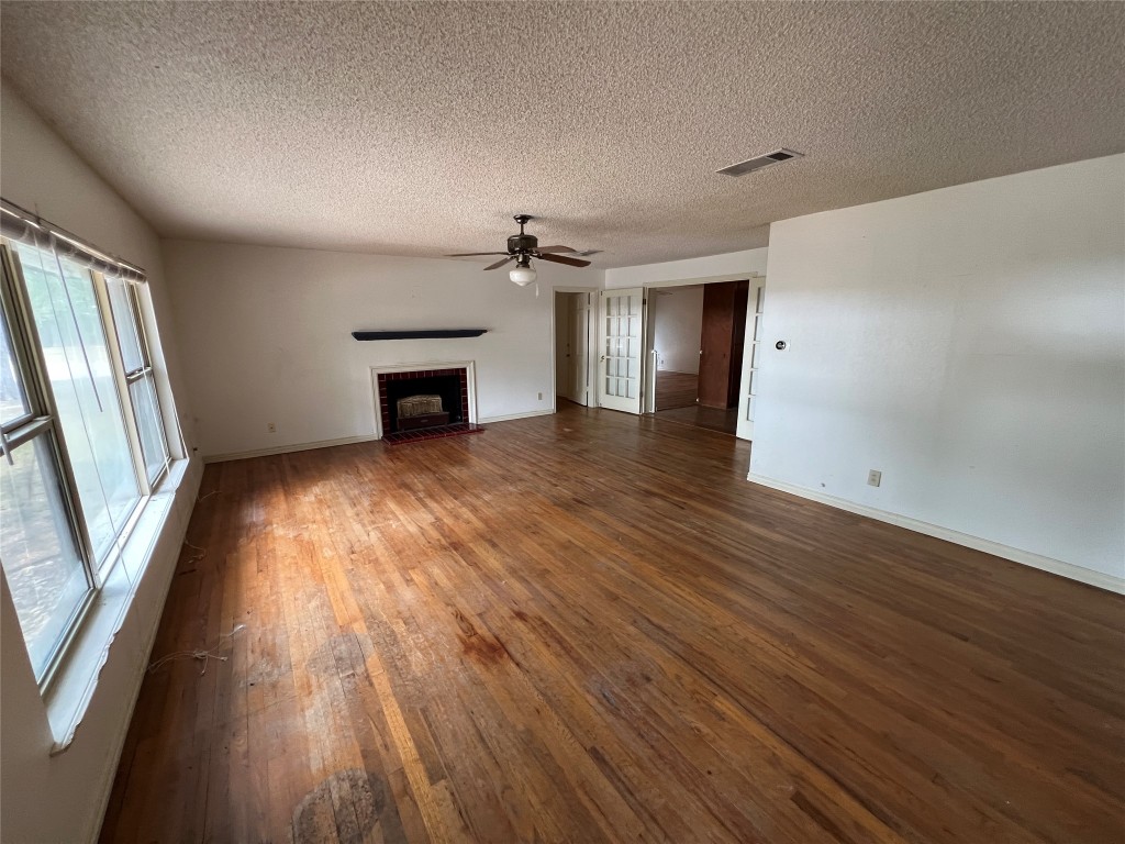 1200 Bentwood Road Austin, TX 78722 - Photo 2 of 16 wooden floor fireplace and natural light in room