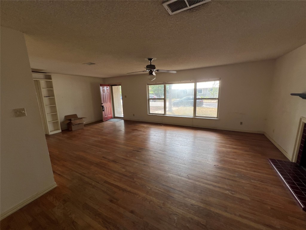 1200 Bentwood Road Austin, TX 78722 - Photo 3 of 16 an empty room with wooden floor and windows