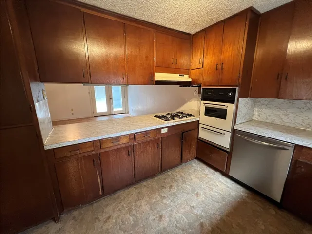a kitchen with cabinets a sink and appliances