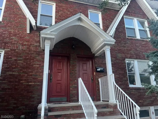 a front view of a house with wooden stairs