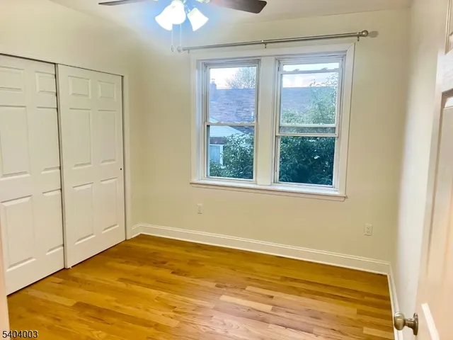 a view of a room with wooden floor and natural light