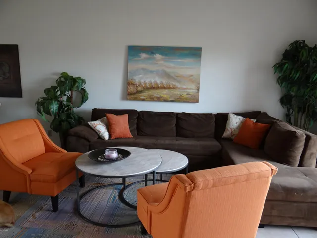 a living room with furniture and a potted plant