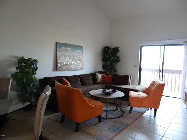 a living room with furniture and a potted plant