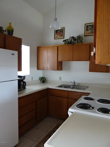 a kitchen with a sink a stove and cabinets