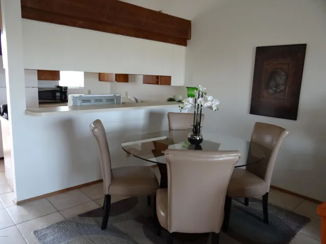 a dining room with furniture and window