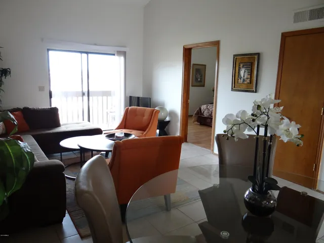 a living room with furniture potted plant and a window