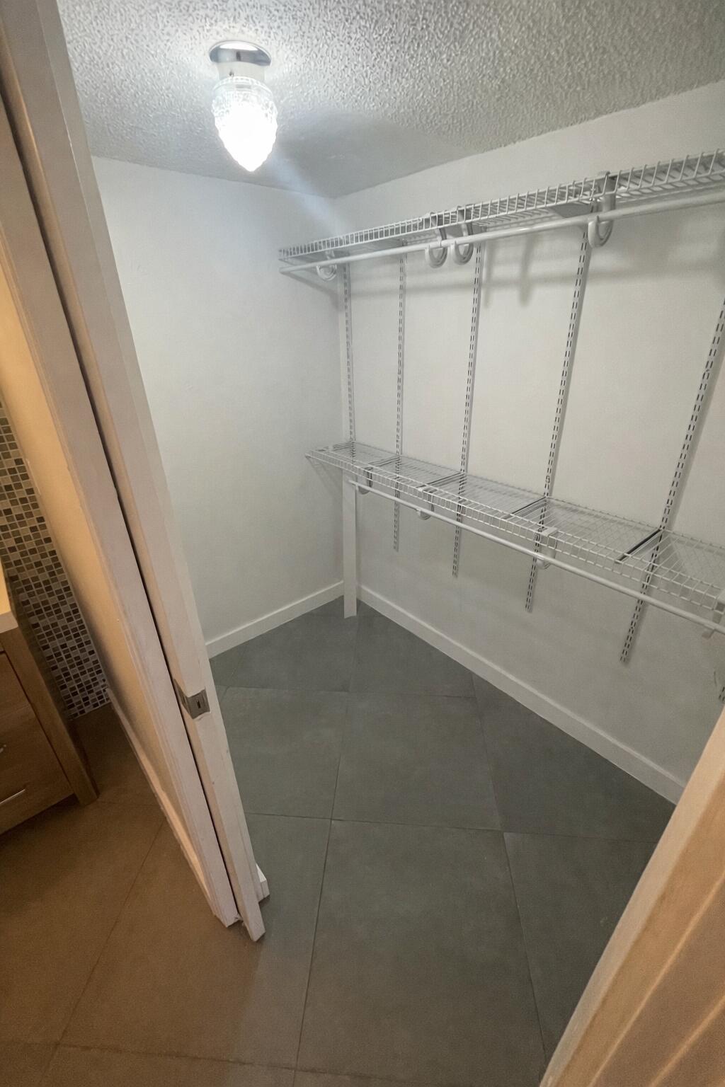 3355 Jaywood Terrace, Unit J113 Boca Raton, FL 33431 - Photo 12 of 34 a view of a room with racks on the wall
