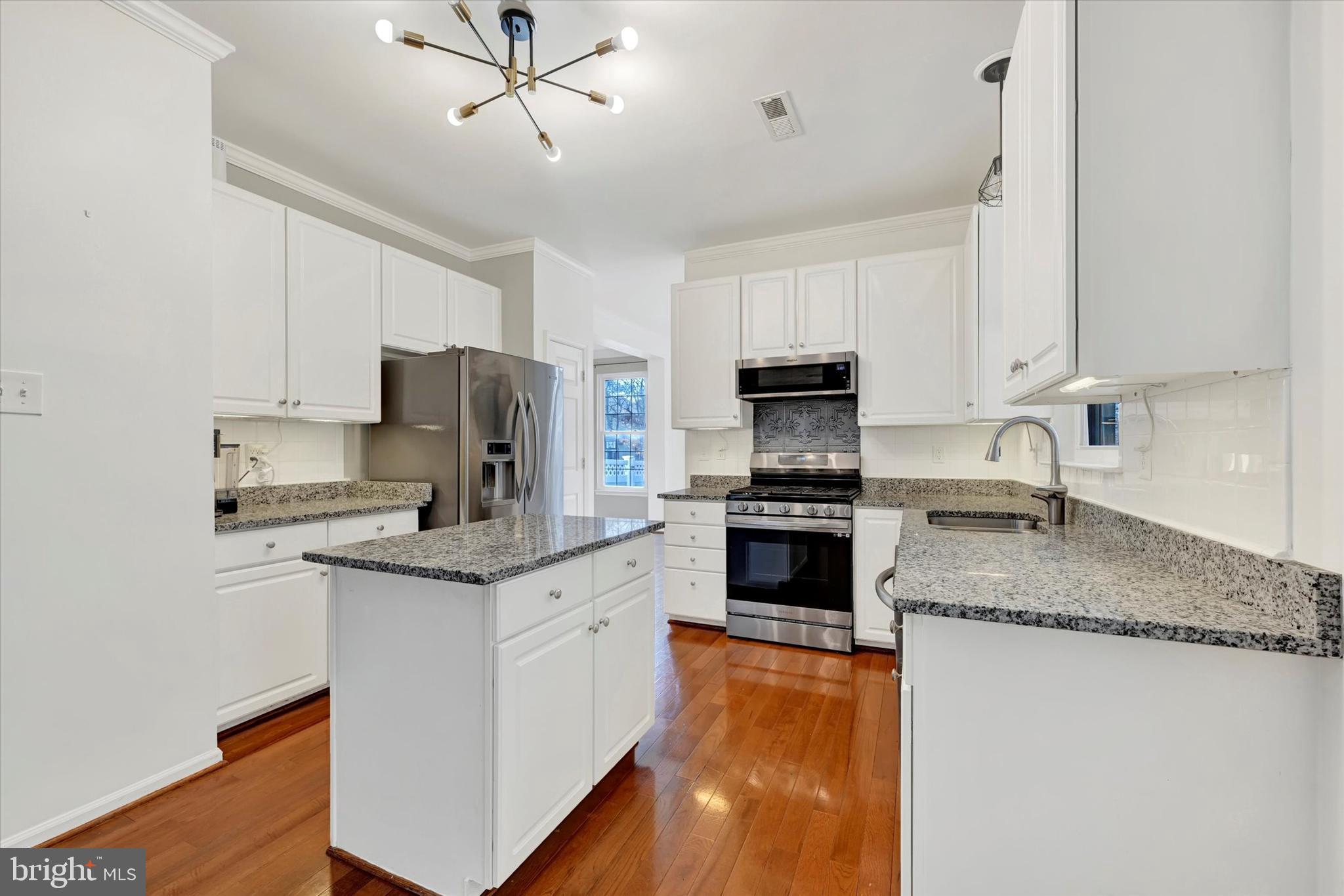 1590 Chapman Road Crofton, MD 21054 - Photo 11 of 70 a kitchen with granite countertop a sink a counter top space appliances and cabinets
