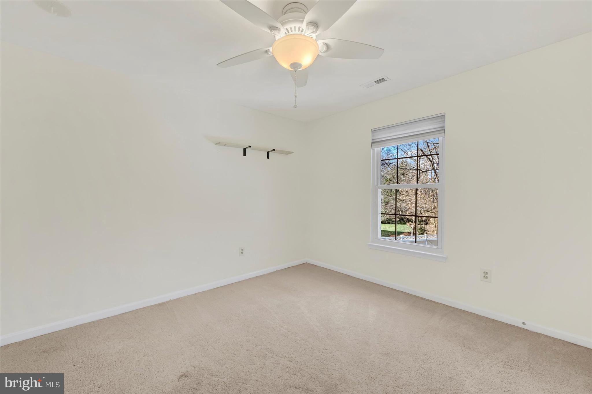 1590 Chapman Road Crofton, MD 21054 - Photo 29 of 70 an empty room with a window and a fan
