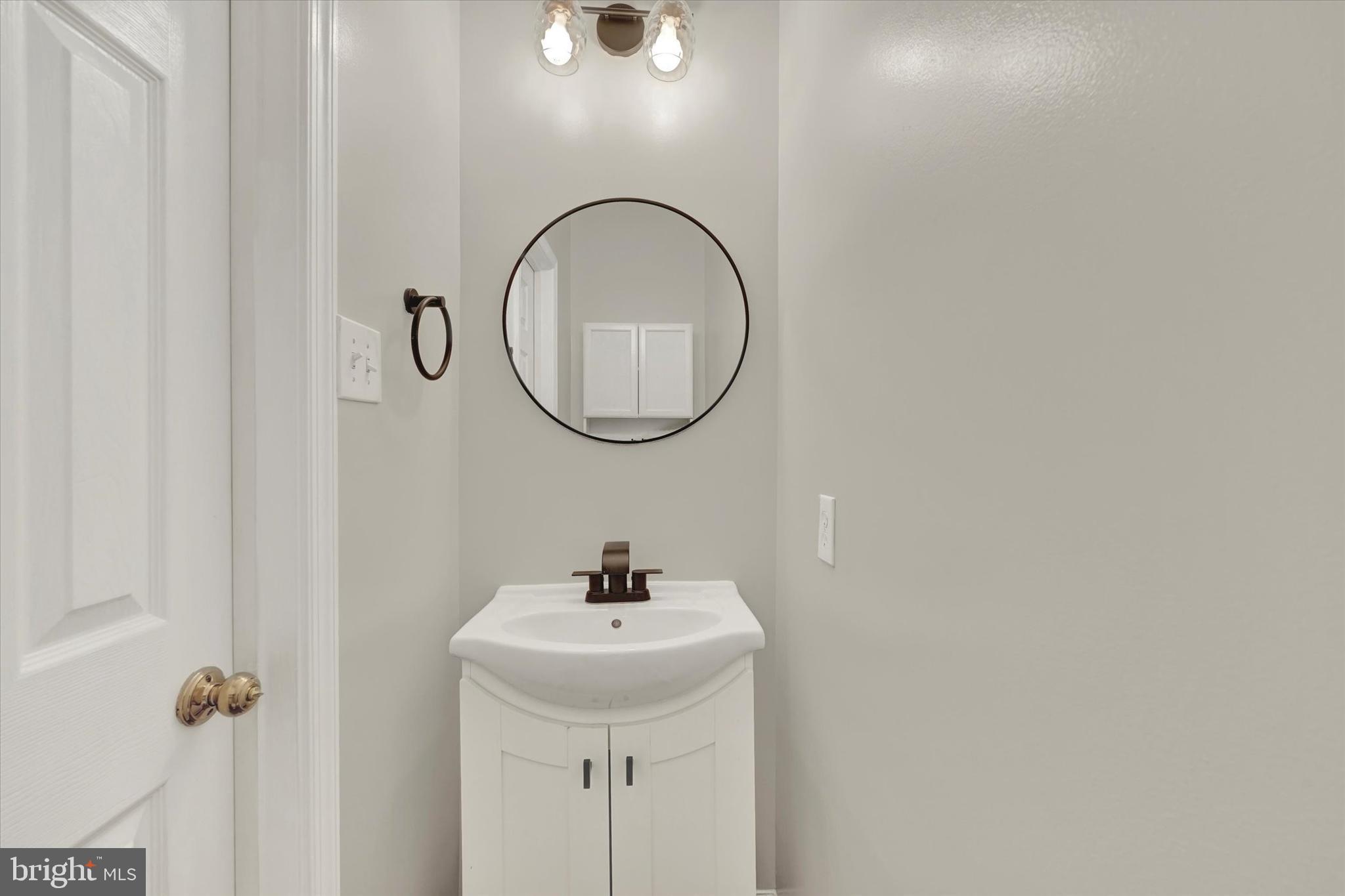 1590 Chapman Road Crofton, MD 21054 - Photo 6 of 70 a bathroom with a sink and a mirror