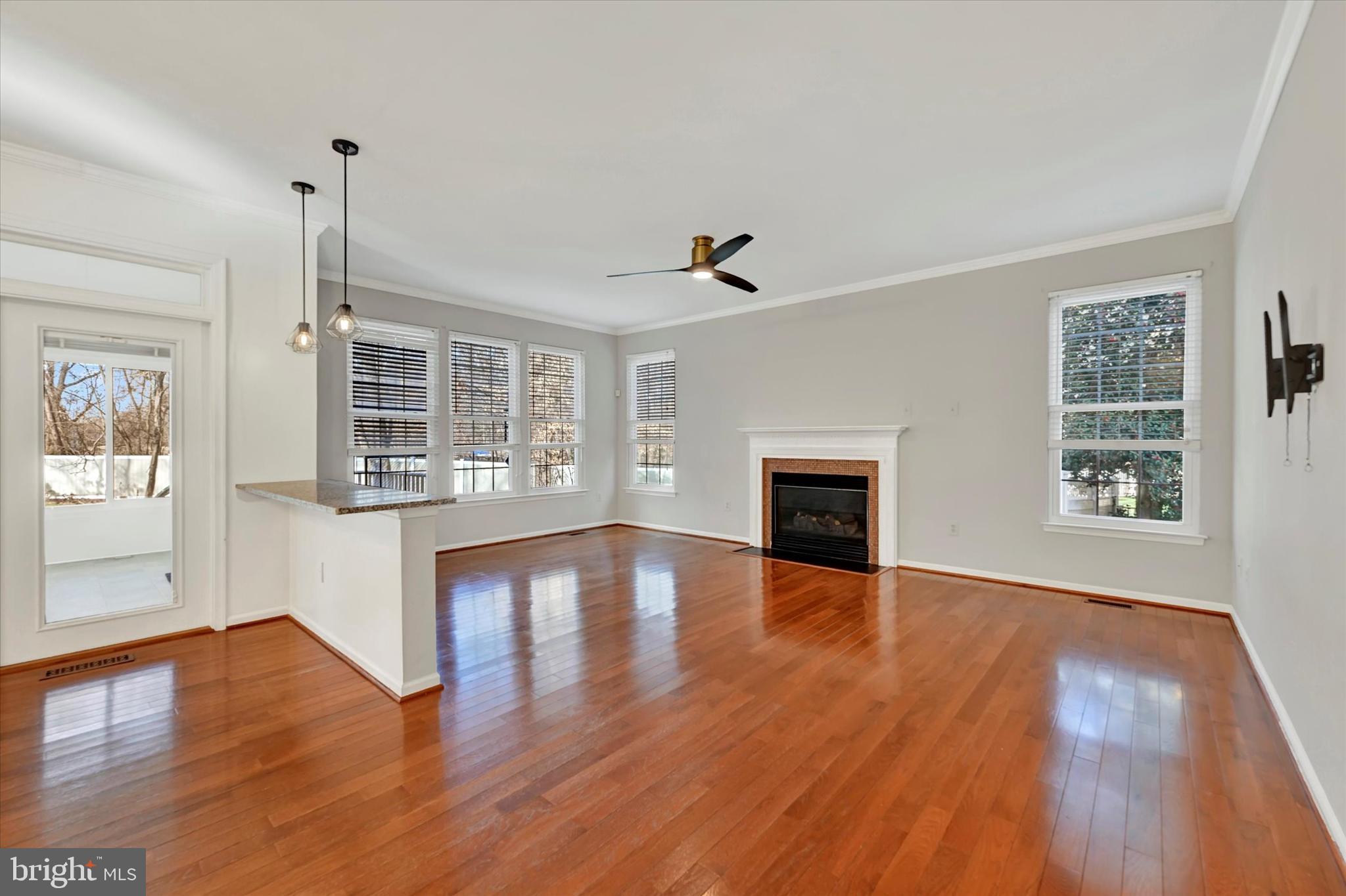 1590 Chapman Road Crofton, MD 21054 - Photo 7 of 70 a view of an empty room with wooden floor and a window