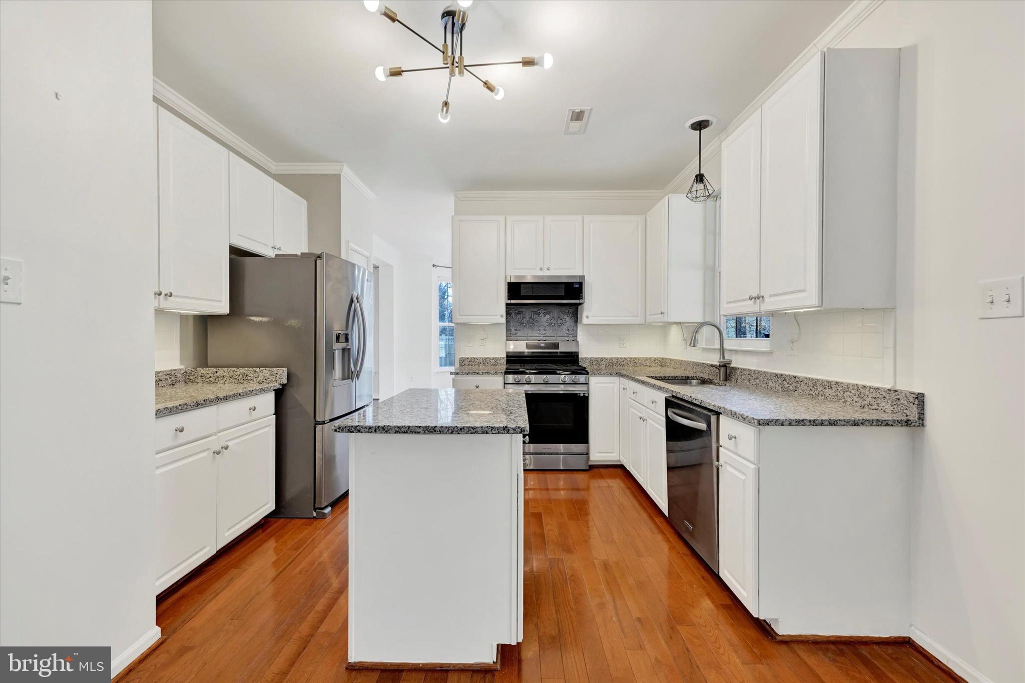 1590 Chapman Road Crofton, MD 21054 - Photo 10 of 70 a kitchen with stainless steel appliances a refrigerator stove and microwave