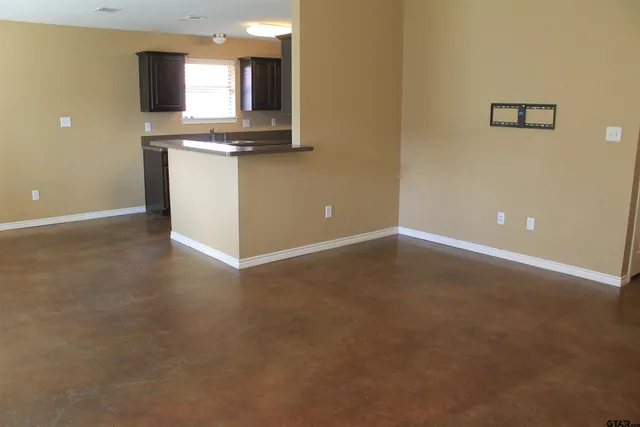 an empty room with wooden floor