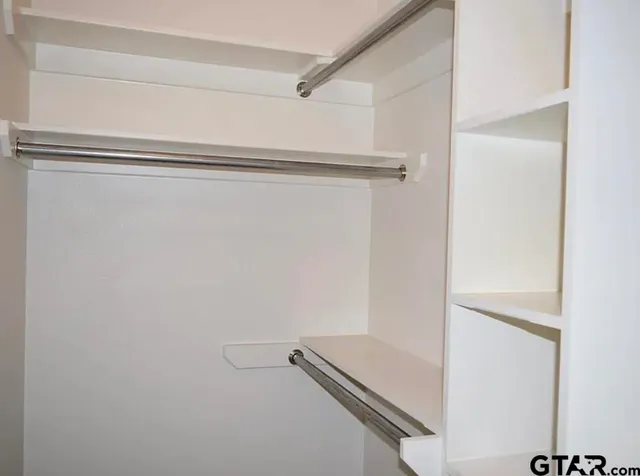 a view of an empty walk in closet