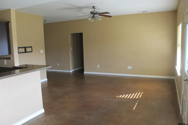a kitchen with granite countertop a sink cabinets and wooden floor