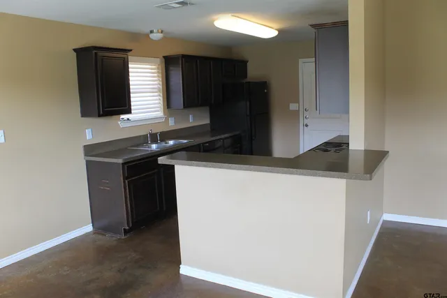 a kitchen with stainless steel appliances granite countertop a stove and a microwave