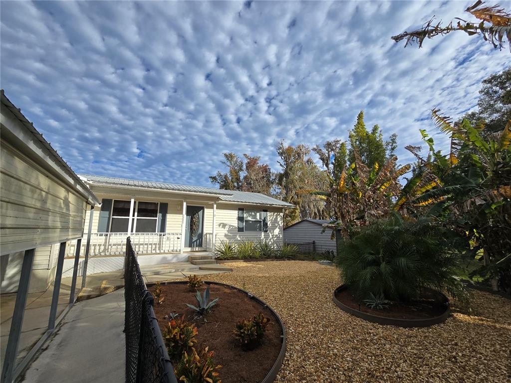24521 Alligator Road Astor, FL 32102 - Photo 2 of 51 a front view of a house with a garden
