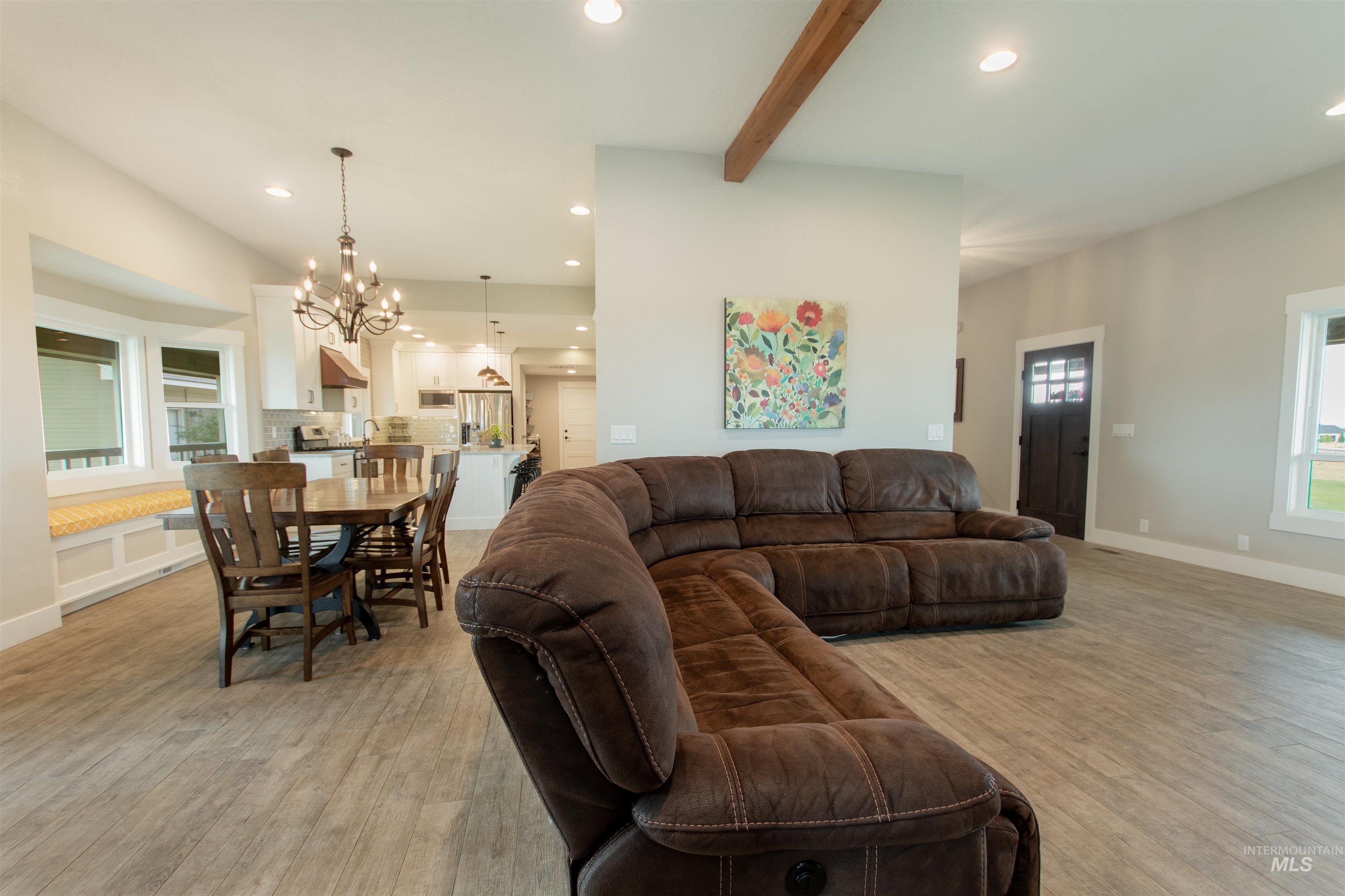 12369 Deer Flat Road Nampa, ID 83686 - Photo 23 of 50 Staircase featuring wood banisters and carpeted steps