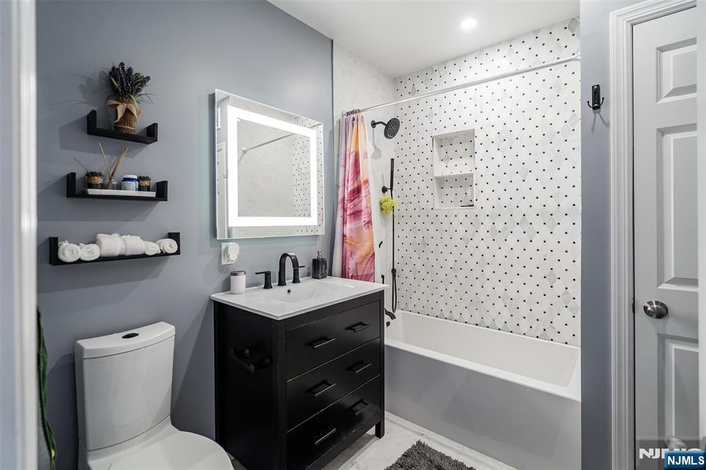 75 Pine Street Hackensack, NJ 07601 - Photo 15 of 23 a bathroom with a sink a toilet and shower