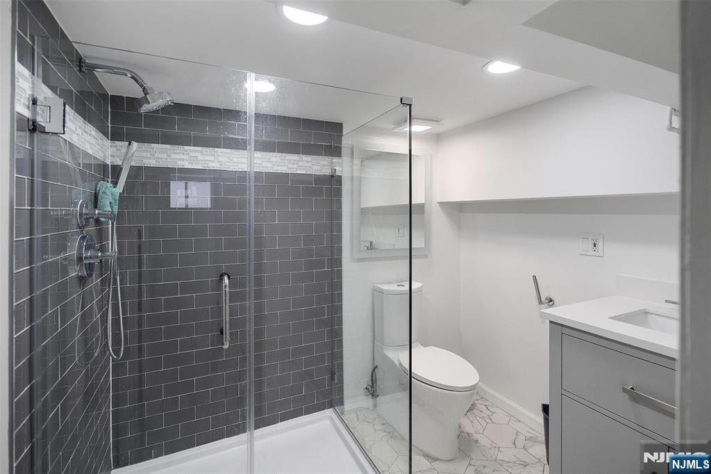 75 Pine Street Hackensack, NJ 07601 - Photo 20 of 23 a bathroom with a shower a toilet and a sink