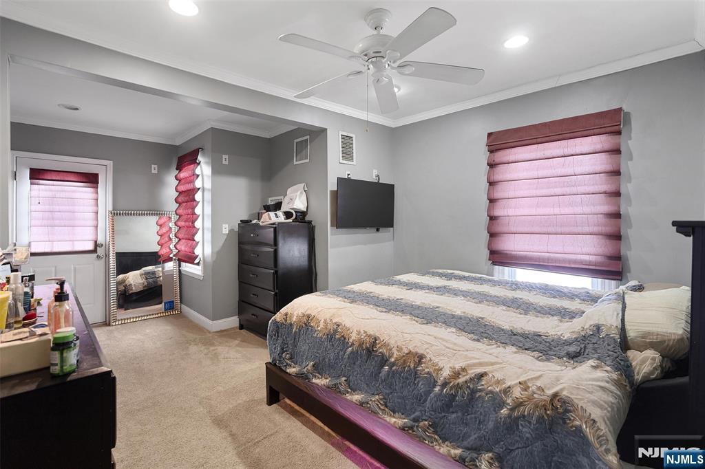 75 Pine Street Hackensack, NJ 07601 - Photo 10 of 23 a bedroom with a bed and a chandelier