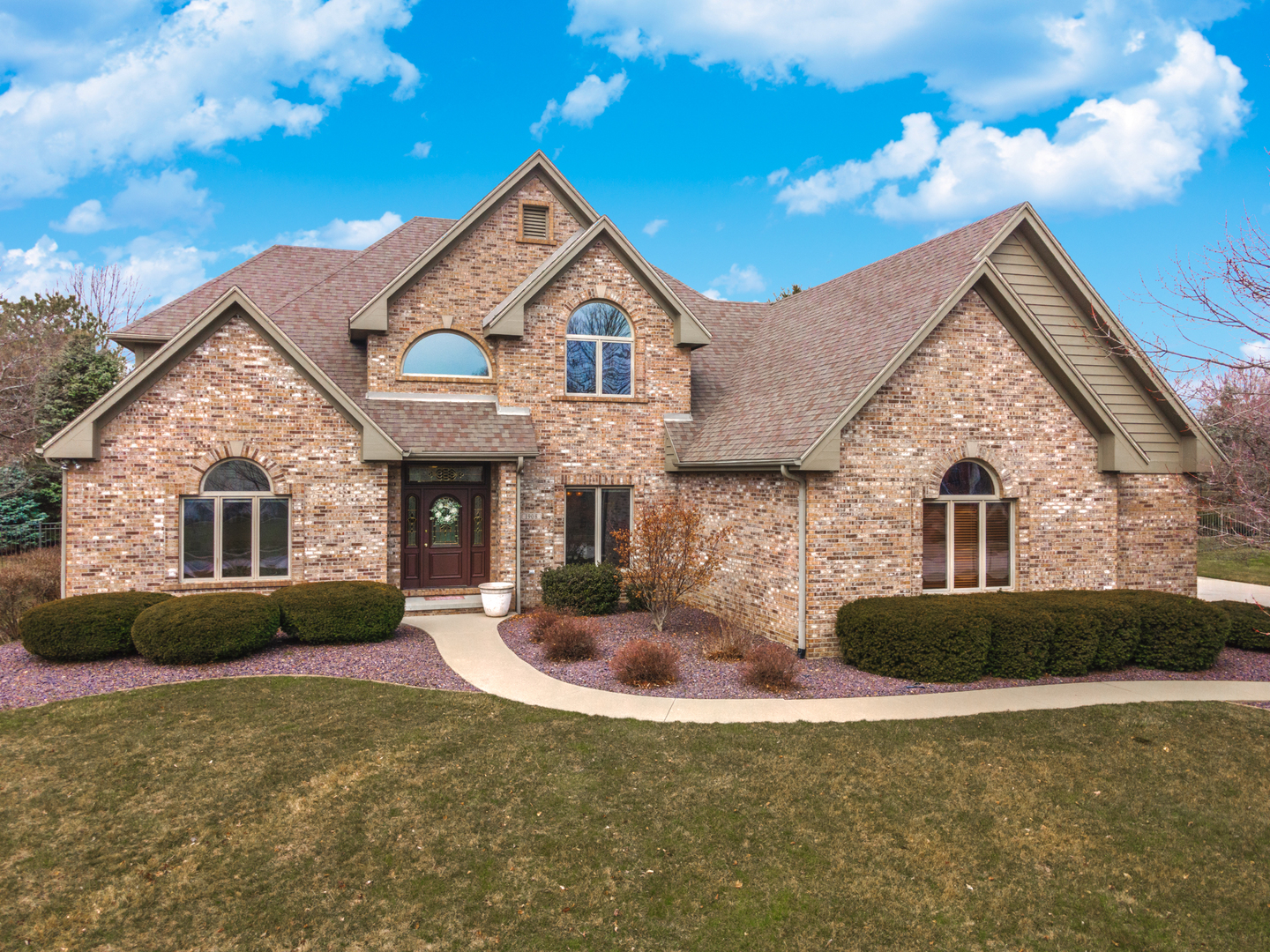 a front view of a house with garden