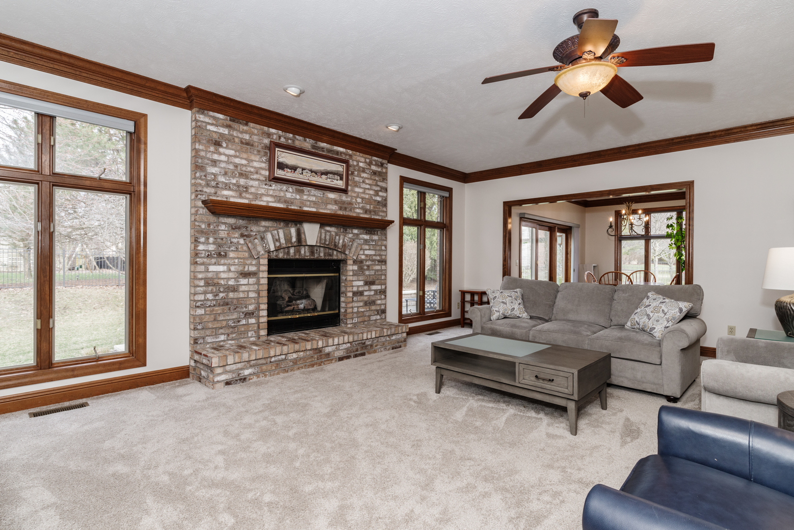 1908 Hackberry Road Bloomington, IL 61704 - Photo 11 of 50 a living room with furniture a fireplace and a large window